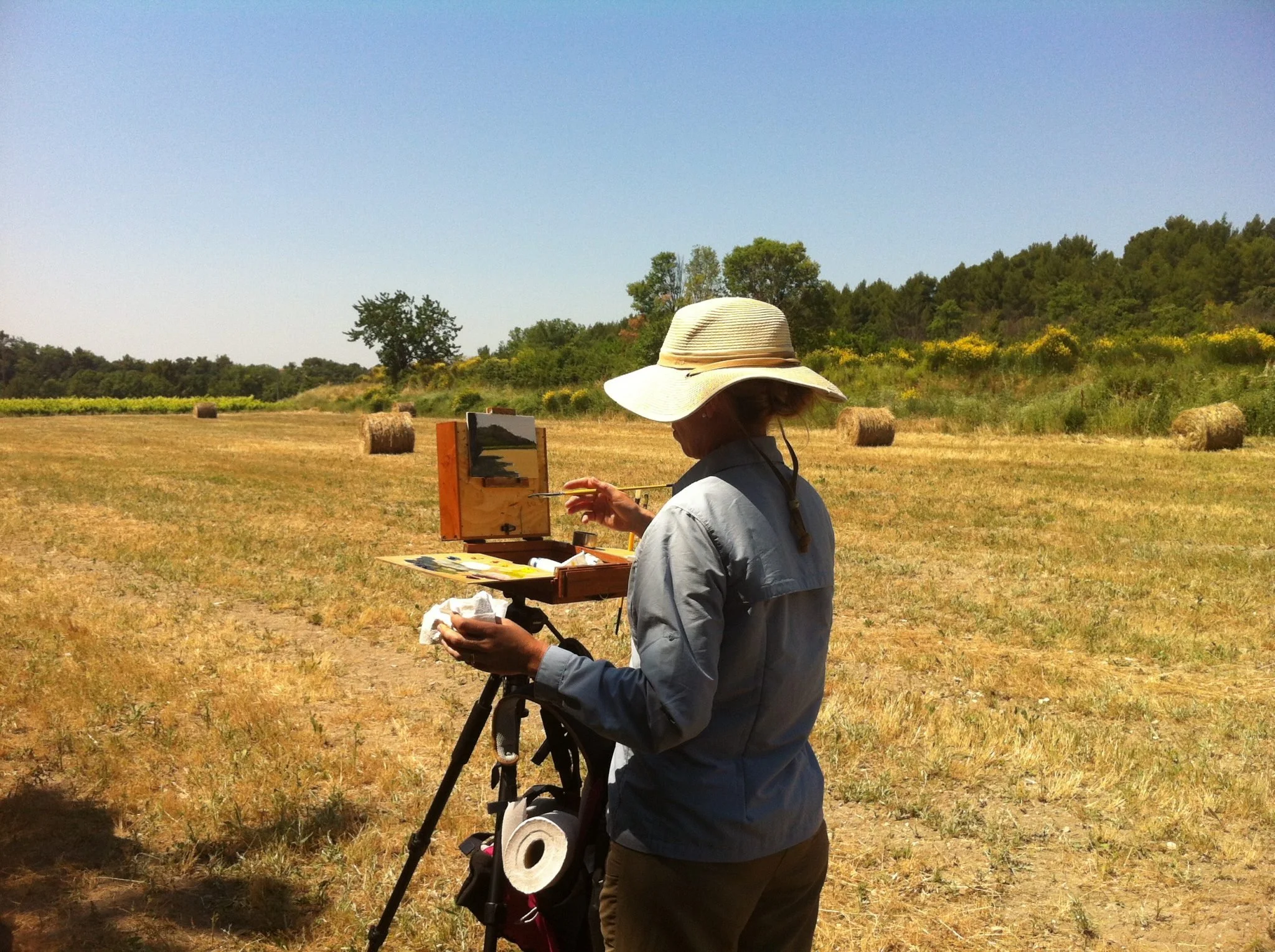 Julian Merrow-Smith painting hay bales outdoors in Provence