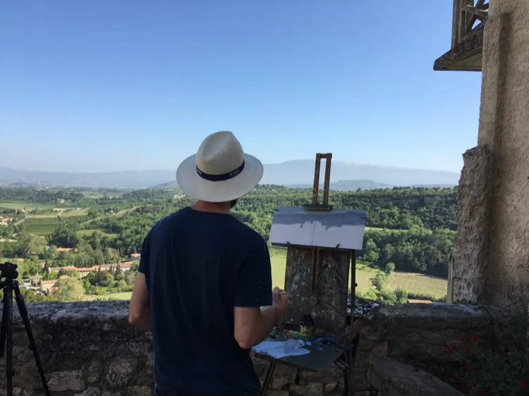 A painter looking across the Provençal landscape from a hill village