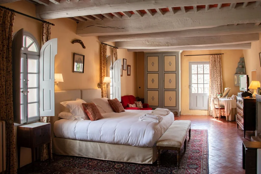 Guest room with antique furnishings at Le Devencet