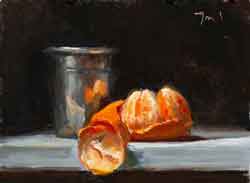 Peeled clementine and silver cup