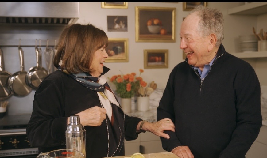 Ina Garten in her New York kitchen with Julian Merrow-Smith's small still-life paintings hanging on the wall behind her